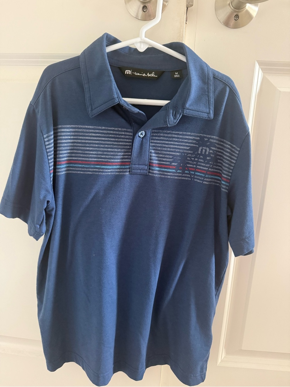 Travis Mathew Boys Navy Polo with Subtle Stripe Detail